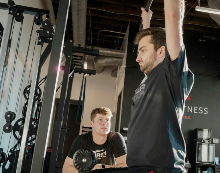 Coach guiding a client in the gym